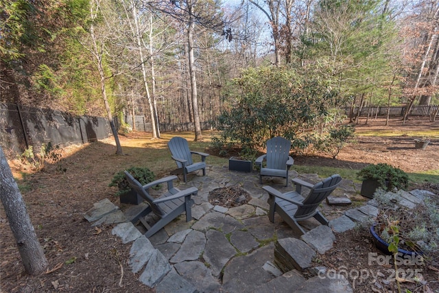 view of patio / terrace with an outdoor fire pit and a fenced backyard