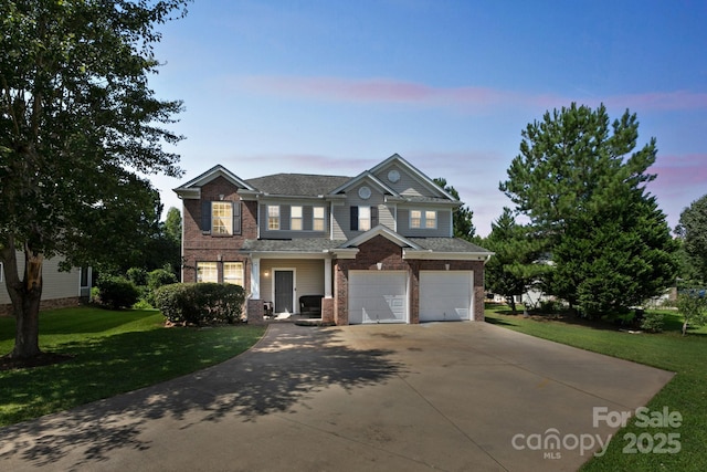 view of front of property with a yard and a garage