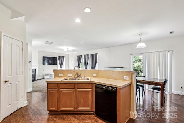 kitchen with decorative light fixtures, black dishwasher, sink, a kitchen island with sink, and dark wood-type flooring