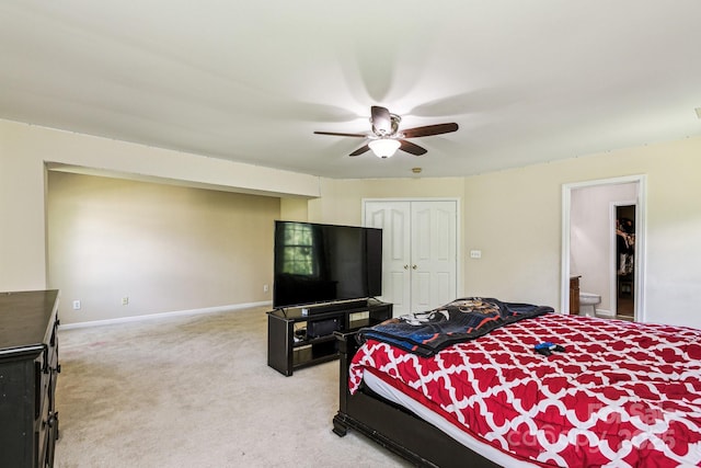 bedroom featuring ceiling fan, connected bathroom, carpet flooring, and a closet