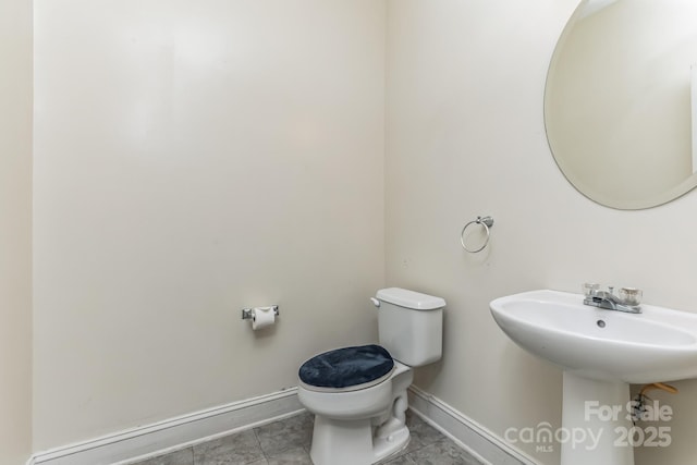 bathroom featuring tile patterned flooring and toilet