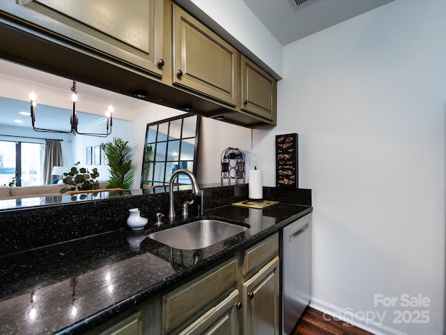 kitchen featuring dark hardwood / wood-style flooring, dishwasher, sink, and dark stone countertops