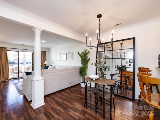 dining space with dark wood-type flooring, crown molding, and ornate columns