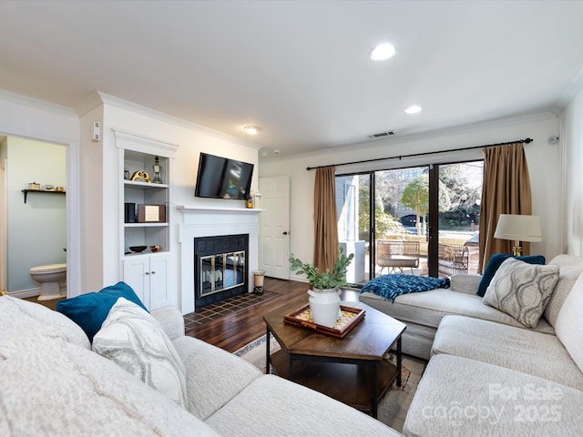 living room featuring ornamental molding and dark wood-type flooring