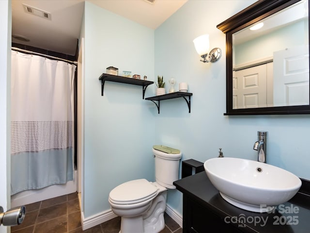 bathroom with a shower with curtain, tile patterned floors, vanity, and toilet