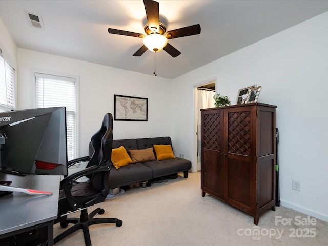 office area with ceiling fan and light carpet