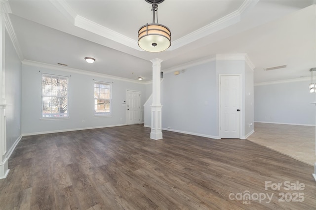 unfurnished living room with decorative columns, a raised ceiling, ornamental molding, and dark hardwood / wood-style flooring