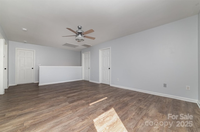 spare room featuring ceiling fan and dark hardwood / wood-style flooring