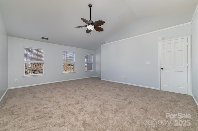 carpeted empty room featuring vaulted ceiling and ceiling fan