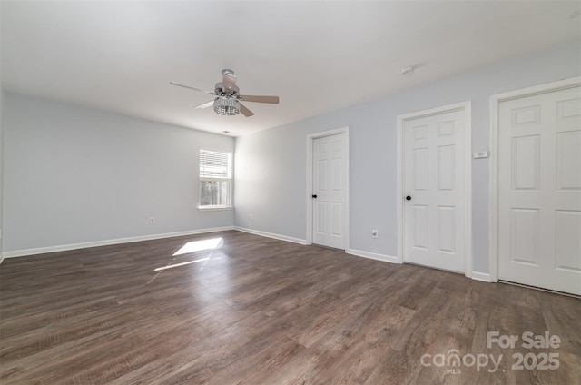 unfurnished bedroom with ceiling fan and dark hardwood / wood-style floors