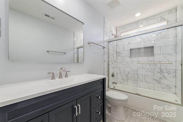 full bathroom with vanity, toilet, and combined bath / shower with glass door