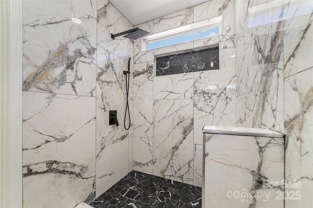 bathroom featuring a tile shower