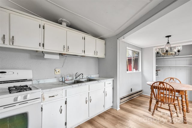 kitchen featuring sink, white cabinetry, a baseboard heating unit, white range with gas cooktop, and decorative light fixtures