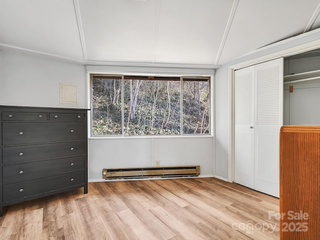 unfurnished bedroom with a baseboard radiator, a closet, and light wood-type flooring