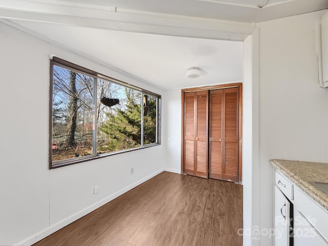 unfurnished bedroom featuring wood-type flooring and a closet