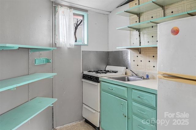 kitchen with white appliances, green cabinets, and sink