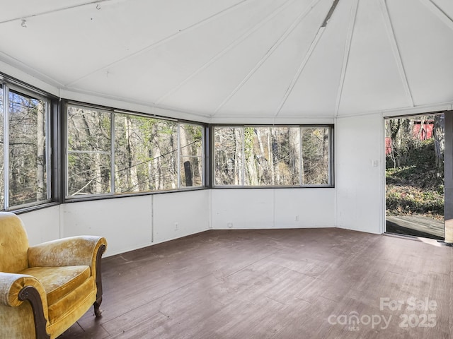 unfurnished sunroom featuring vaulted ceiling