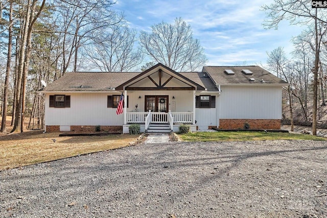 ranch-style home with a porch and a front yard