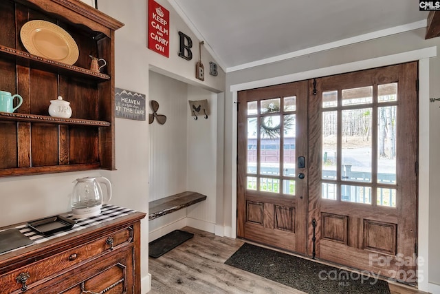 mudroom featuring french doors, light hardwood / wood-style floors, vaulted ceiling, and a wealth of natural light