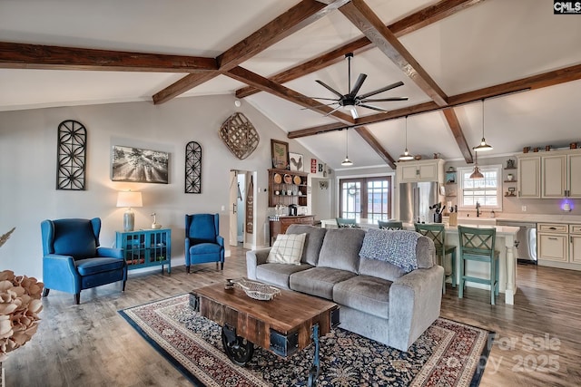 living room featuring french doors, sink, vaulted ceiling with beams, light hardwood / wood-style flooring, and ceiling fan