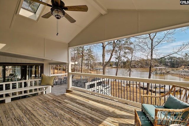 wooden terrace featuring ceiling fan and a water view