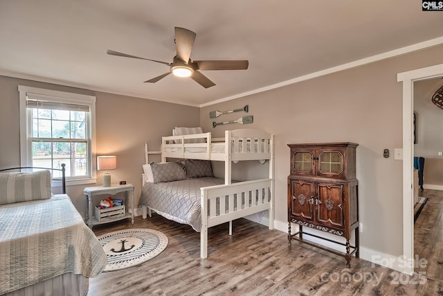 bedroom with crown molding, wood-type flooring, and ceiling fan