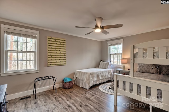 bedroom featuring crown molding, hardwood / wood-style floors, and ceiling fan