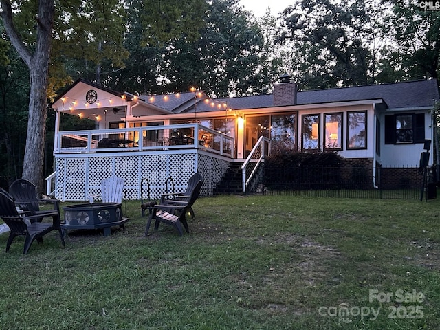 back of house with a yard and a deck