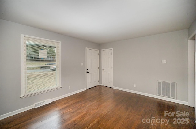 empty room featuring dark hardwood / wood-style floors