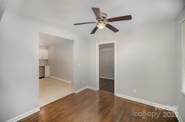 spare room featuring ceiling fan and dark hardwood / wood-style floors