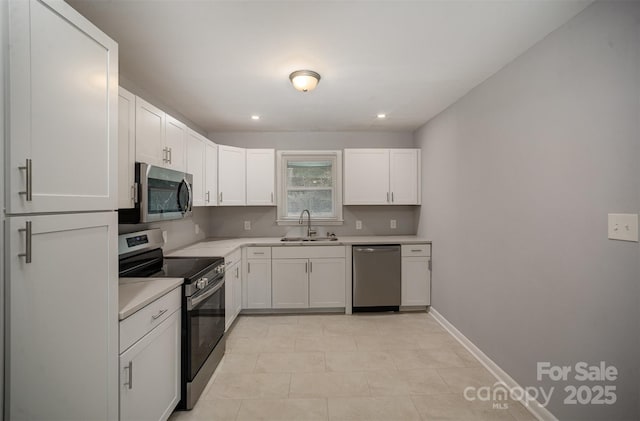 kitchen with sink, backsplash, stainless steel appliances, white cabinets, and light tile patterned flooring