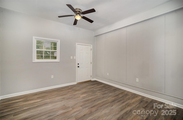 empty room with ceiling fan and dark hardwood / wood-style flooring