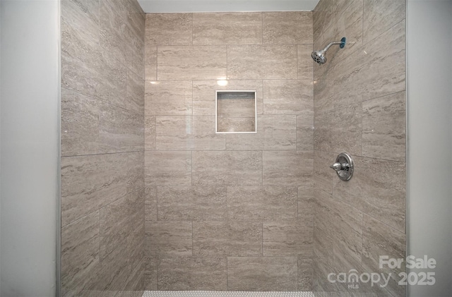 bathroom with a tile shower