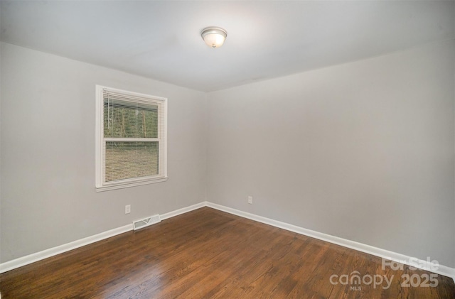 empty room featuring dark hardwood / wood-style flooring