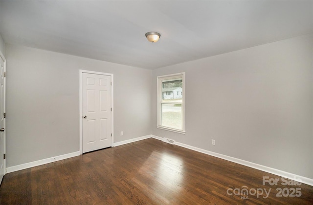 empty room featuring dark wood-type flooring