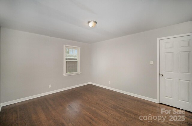 unfurnished room featuring dark hardwood / wood-style flooring