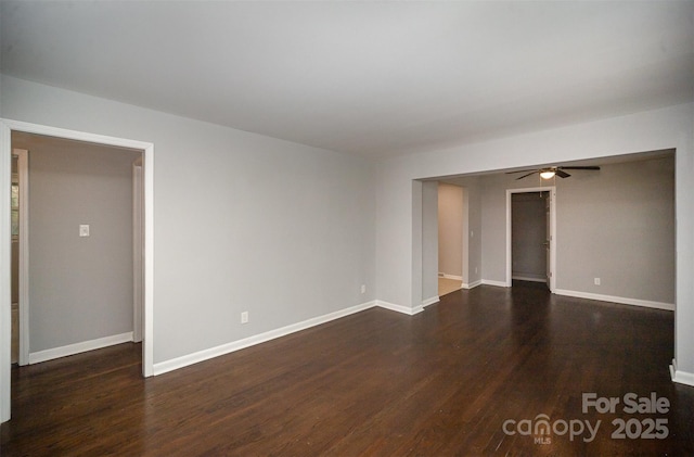 spare room featuring ceiling fan and dark hardwood / wood-style flooring