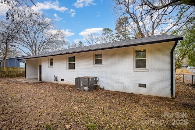 back of property with central AC