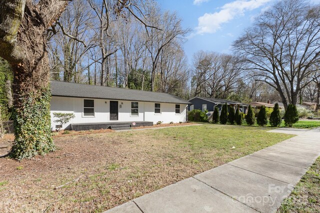 3843 Foxford Pl, Charlotte, NC 28215 - ranch-style home with a front yard and roof with shingles