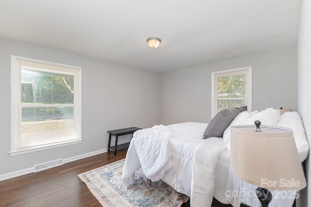 3843 Foxford Pl, Charlotte, NC 28215 - bedroom with visible vents, multiple windows, baseboards, and dark wood-style floors