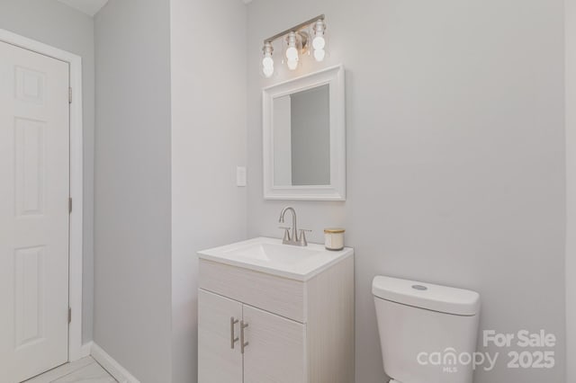 3843 Foxford Pl, Charlotte, NC 28215 - bathroom with vanity, toilet, and baseboards
