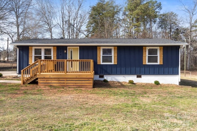 view of front of home with a deck and a front yard