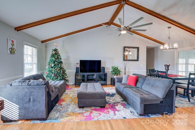 living room with hardwood / wood-style flooring, a chandelier, and a wealth of natural light