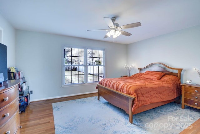 bedroom with hardwood / wood-style flooring and ceiling fan