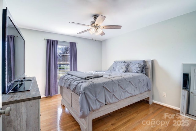 bedroom with ceiling fan and light wood-type flooring