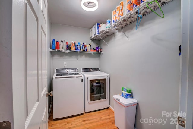 washroom featuring washer and dryer and light hardwood / wood-style flooring