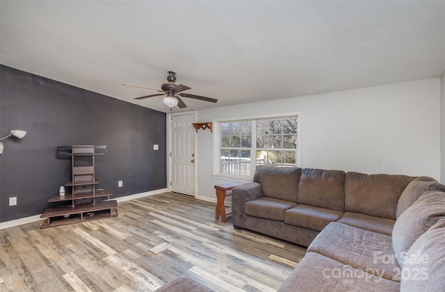 living room with ceiling fan and light hardwood / wood-style floors