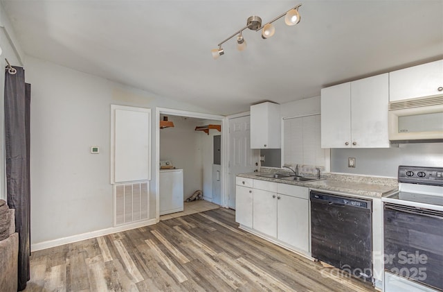 kitchen with washer / dryer, sink, white cabinetry, wood-type flooring, and white appliances