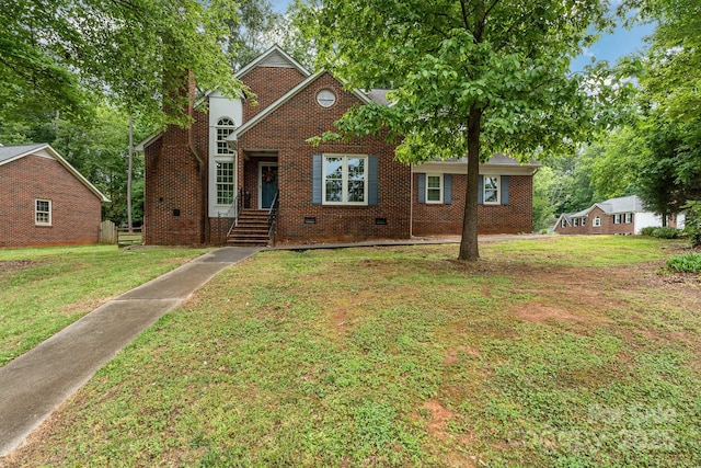 traditional-style home with brick siding, a front yard, and crawl space
