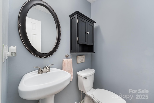 bathroom with toilet and a sink